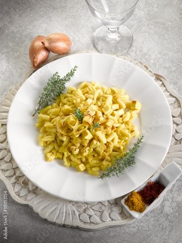 malloreddus pasta with mozzarella onions and saffron photo