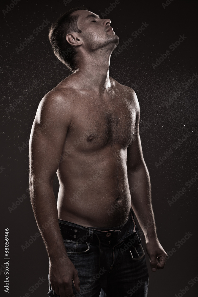 Fototapeta premium athletic young man with dewdrops on body