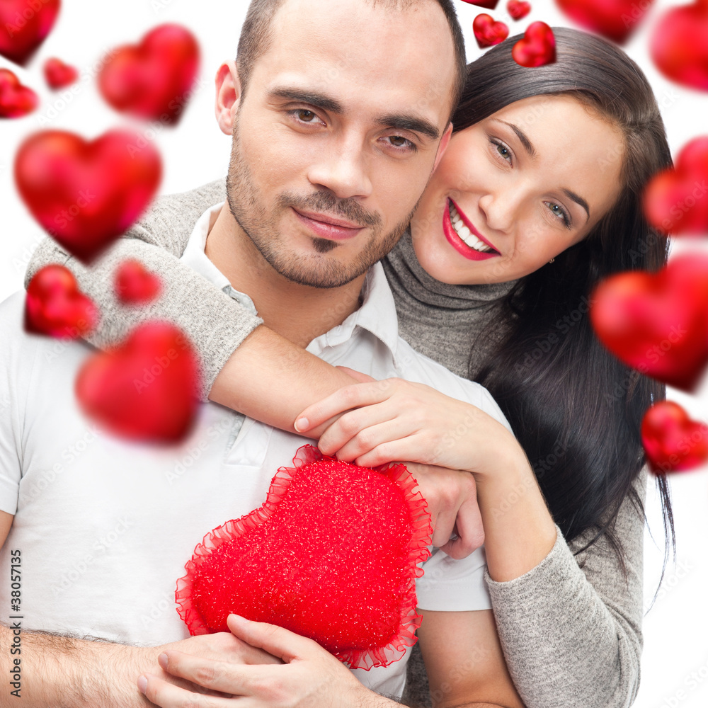 Beautiful young love couple embracing against a white background Beautiful young love couple embracing against a white background