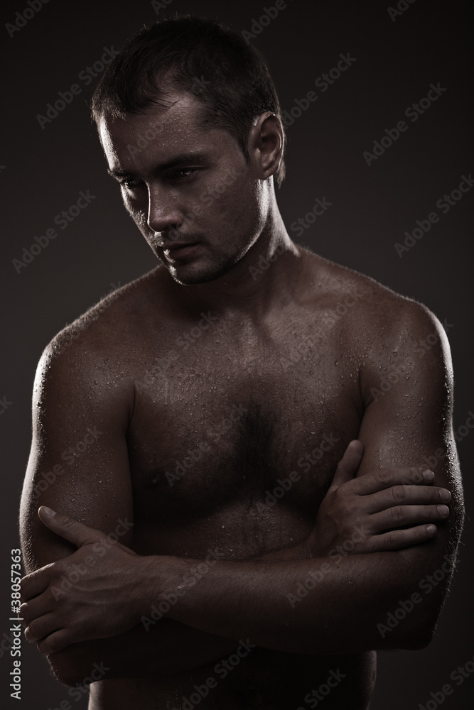 Fototapeta premium athletic young man with dewdrops on body