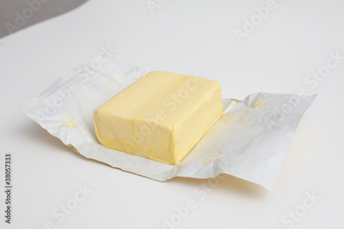big piece of butter on a white package paper