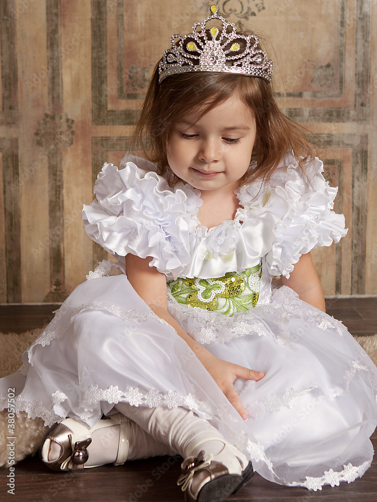 little girl in white dress with a tiara on her head Stock Photo | Adobe ...
