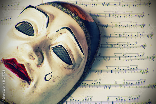 Pierrot mask over written music , retro styled photo