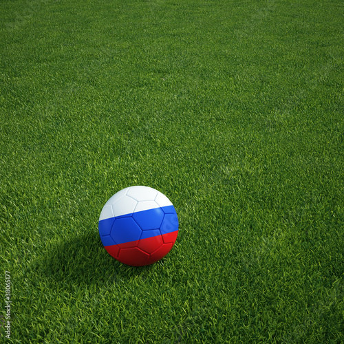 Russian soccerball lying on a grass field