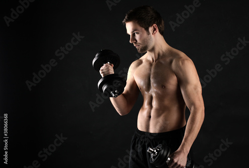A young athlete with the dumbbells
