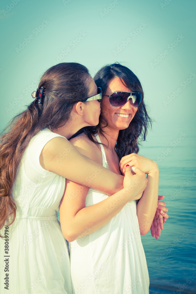 Two Female Friends Embraced on the Beach Two Female Friends Embraced on the Beach