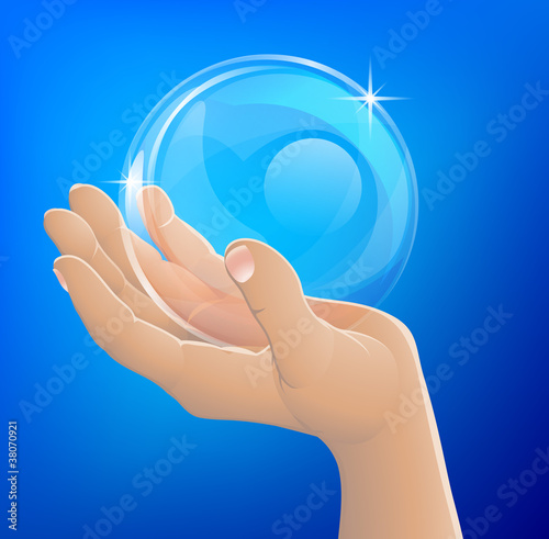 Hand holding bubble or glass ball