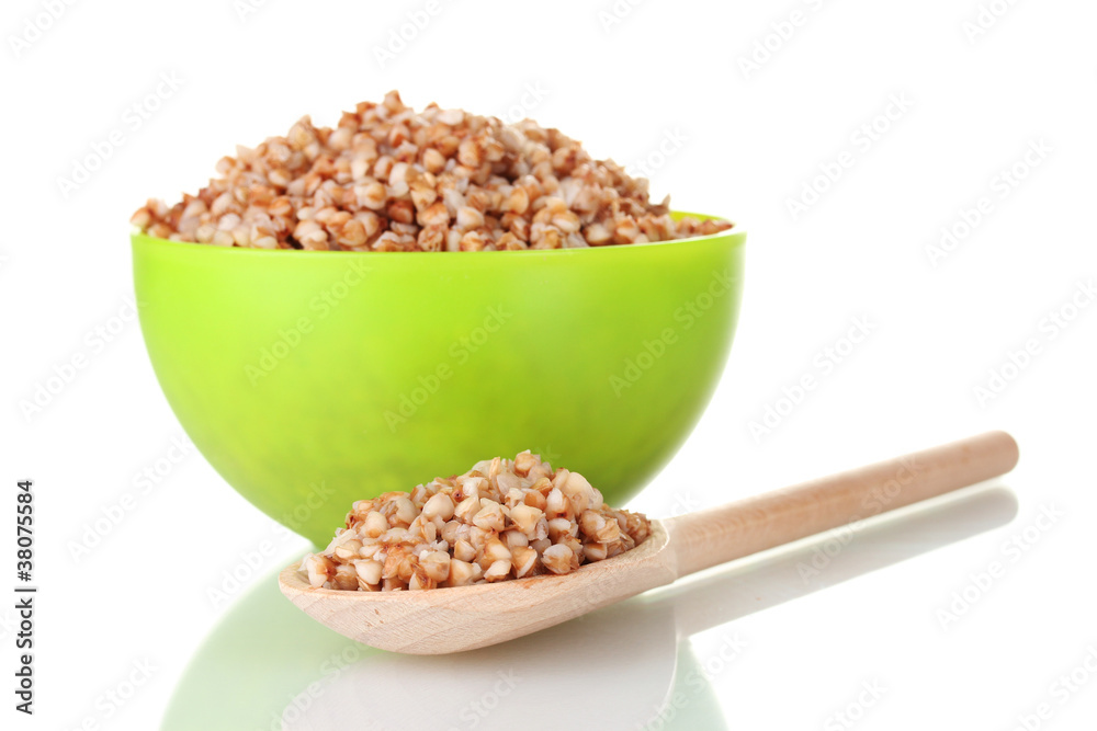 Boiled buckwheat in a green bowl isolated on white Boiled buckwheat in a green bowl isolated on white