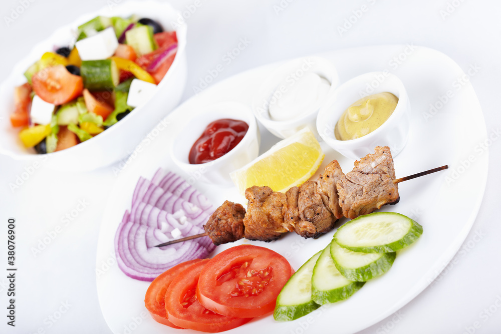 Kebab with fresh vegetables and greek salad Kebab with fresh vegetables and greek salad