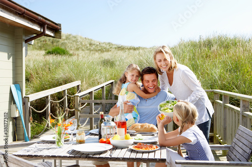 Family on vacation eating outdoors photo