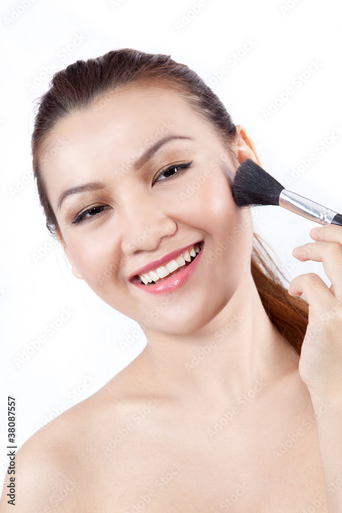 asian woman smile while applying make up