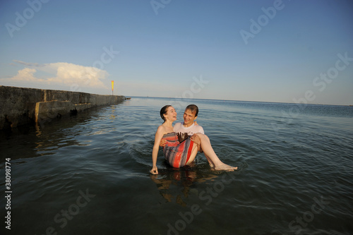Young couple hugging in the sea
