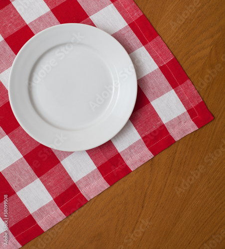 white plate on wooden table...