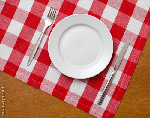 Knife, white plate and fork...