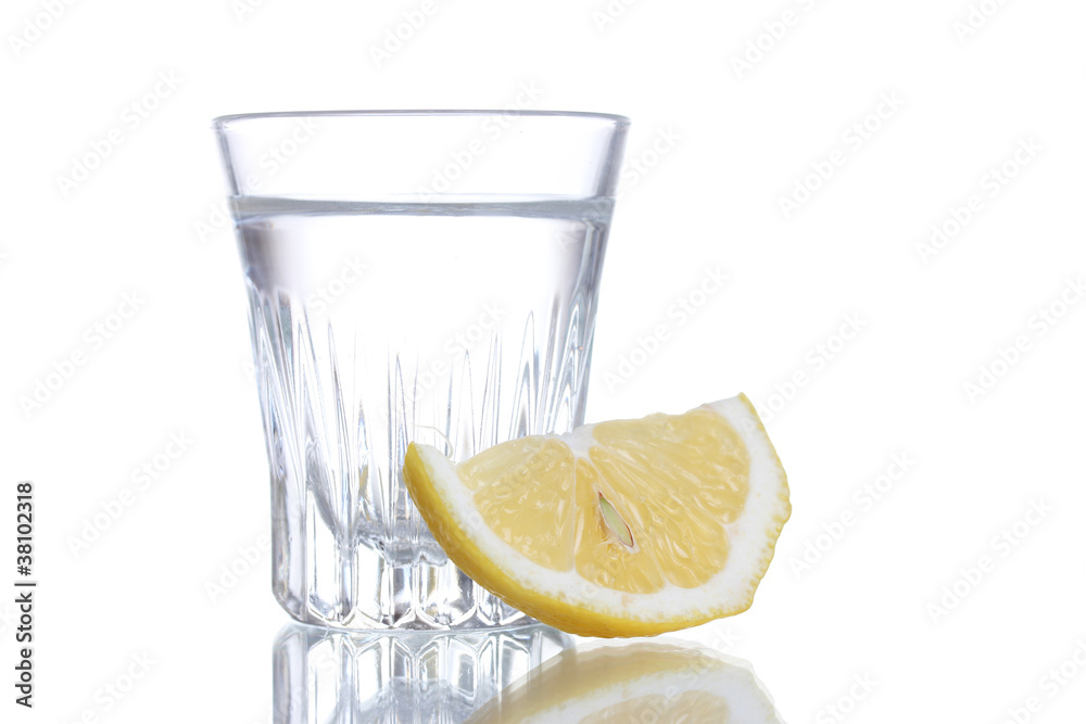 Glass of vodka with lemon isolated on white Glass of vodka with lemon isolated on white