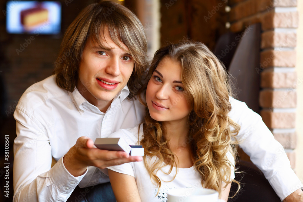 Young couple with engagement ring in a restaurant Young couple with engagement ring in a restaurant