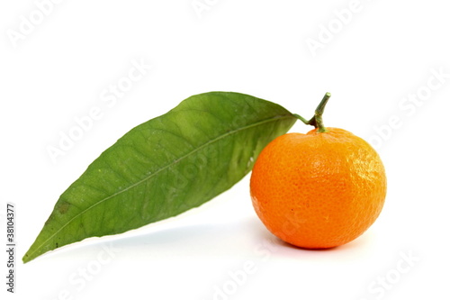 Juicy mandarin with green leaf