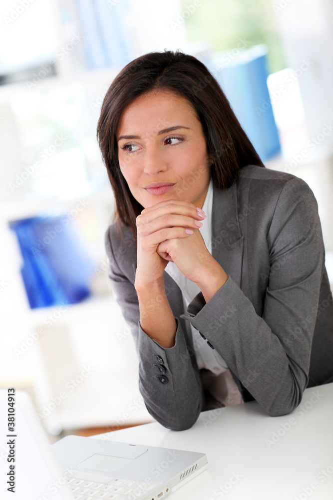 Businesswoman sitting in front of laptop computer Businesswoman sitting in front of laptop computer