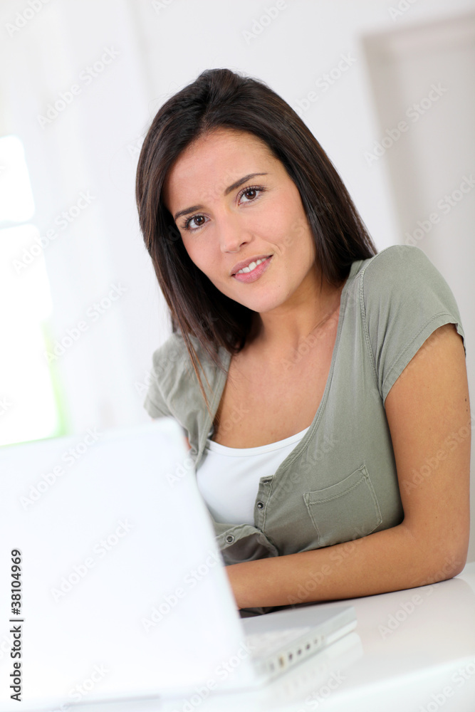 Beautiful young woman working at home on laptop computer Beautiful young woman working at home on laptop computer