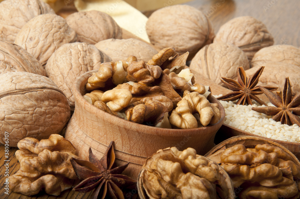 Walnut, wood nut, anise and sesame against a dark background Walnut, wood nut, anise and sesame against a dark background