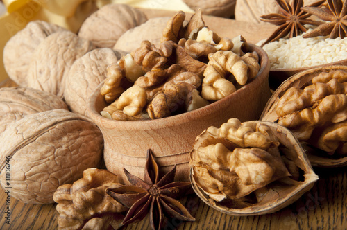 Walnut, wood nut, anise and sesame against a dark background