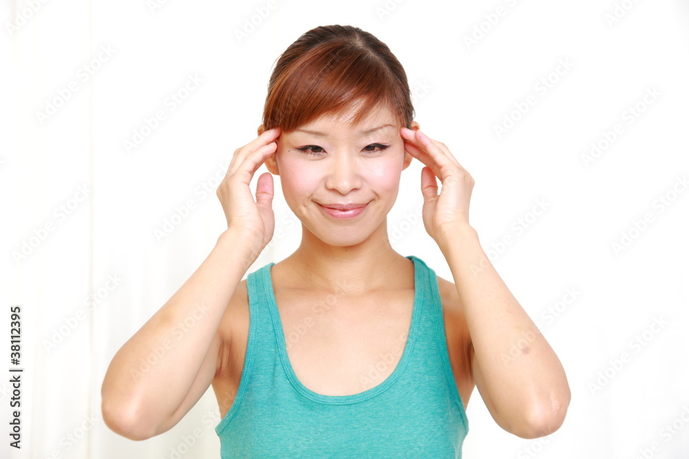 young japanese woman doing self head massage young japanese woman doing self head massage