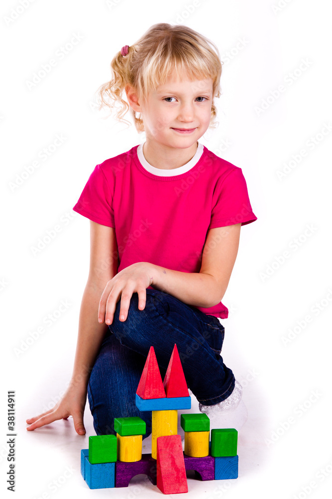 Beautiful girl building a castle with cubes Beautiful girl building a castle with cubes
