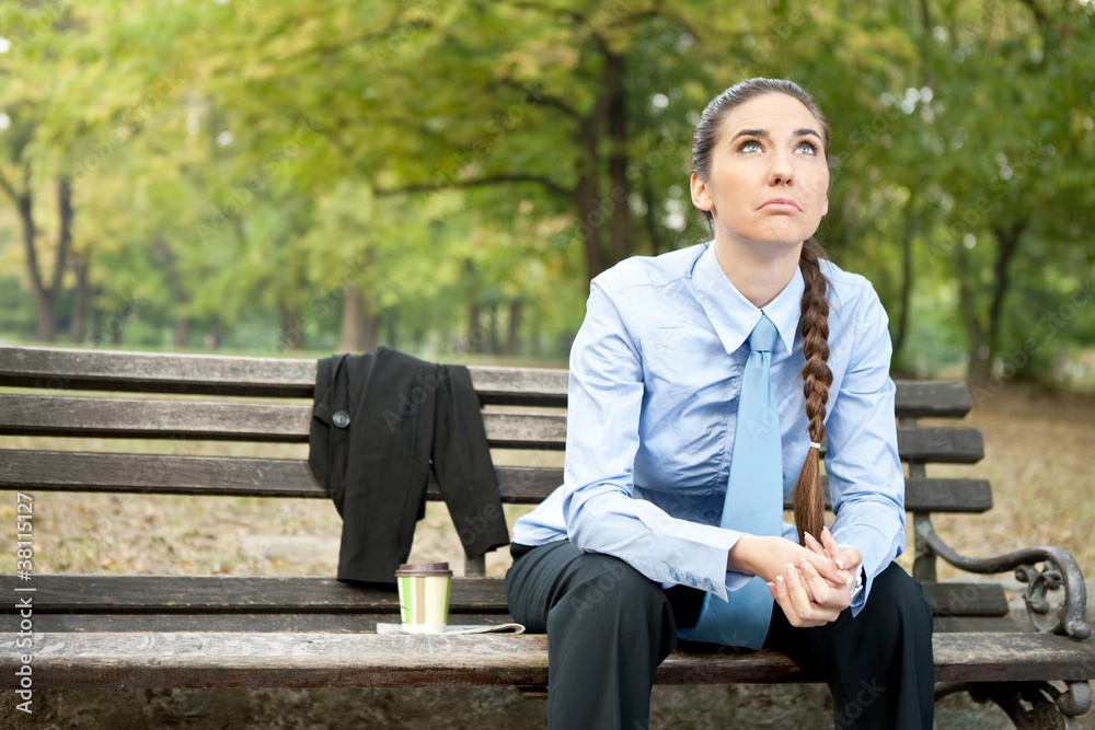 sad businesswoman sitting on bench sad businesswoman sitting on bench