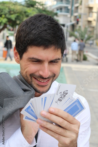 A businessman is holding cards, at the street photo