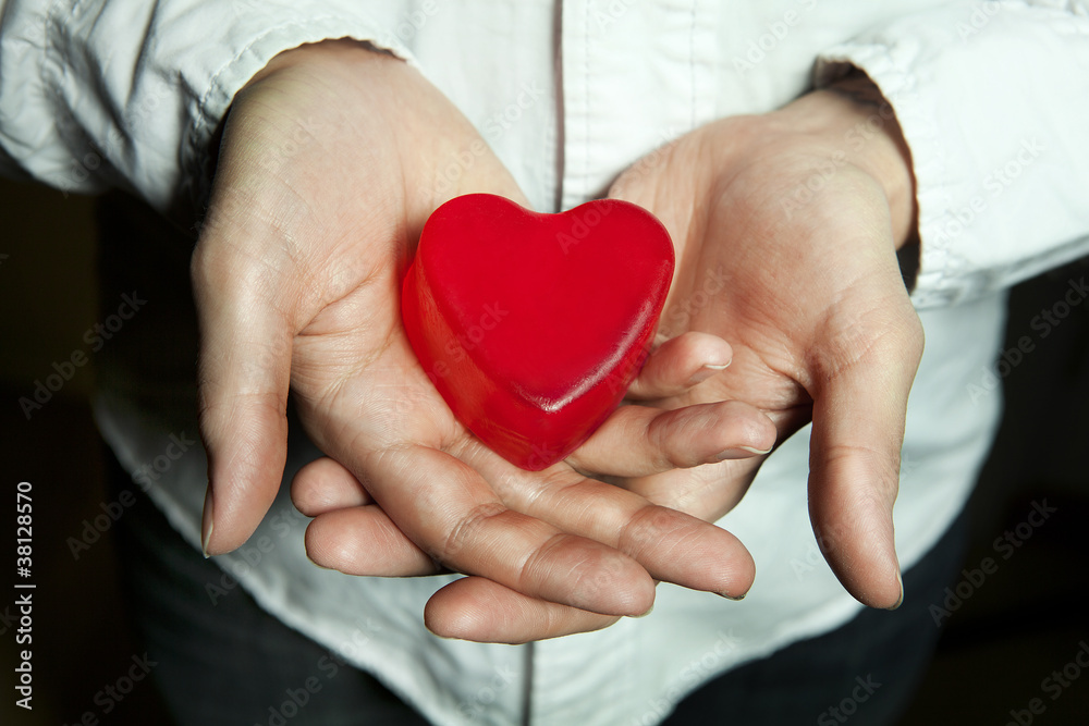 man holding a red heart in hands man holding a red heart in hands