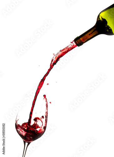 Wine pouring from bottle into glass photo
