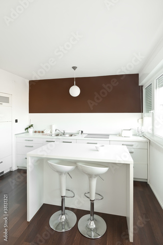 Modern kitchen with brown wall above the counter