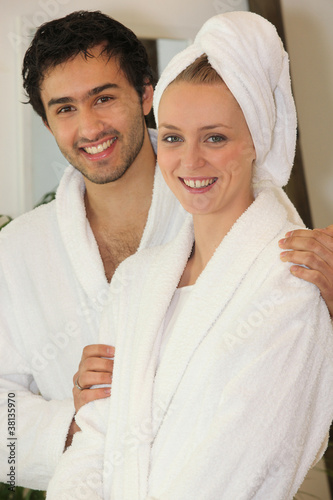 Young couple in bathrobes