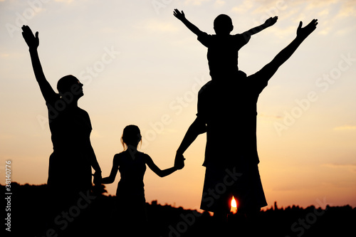 Silhouette, happy children with mother and father,