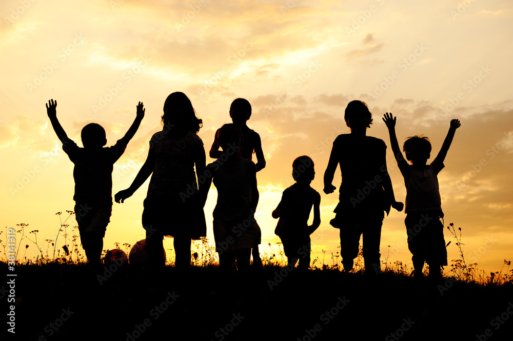 Silhouette, group of happy children playing on meadow Silhouette, group of happy children playing on meadow