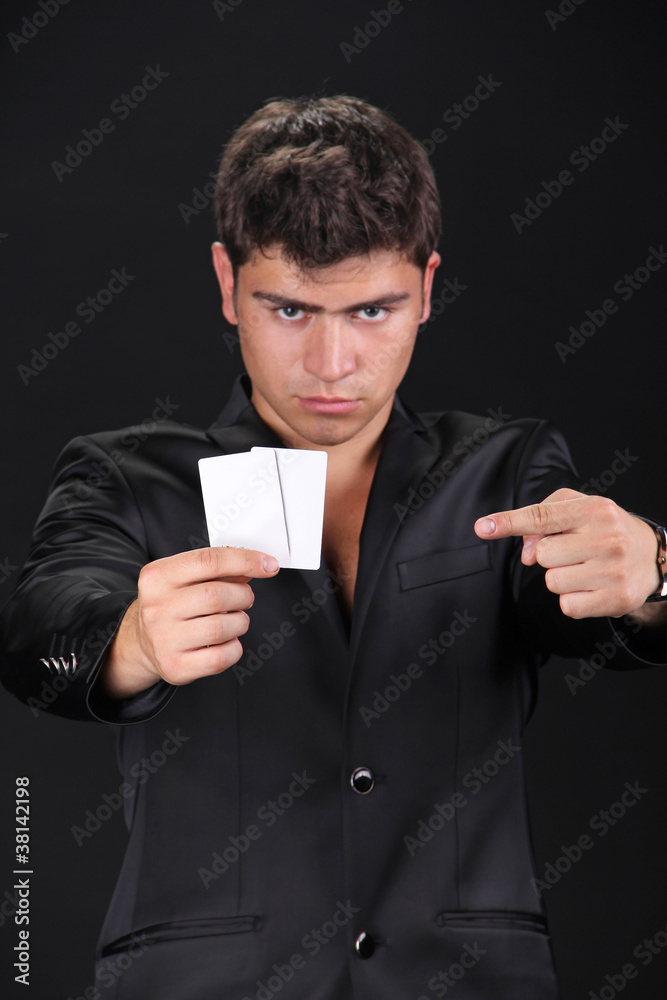 Portrait of man with blank card isolated on black background. Portrait of man with blank card isolated on black background.