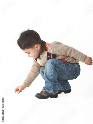 Adorable child in studio crouching