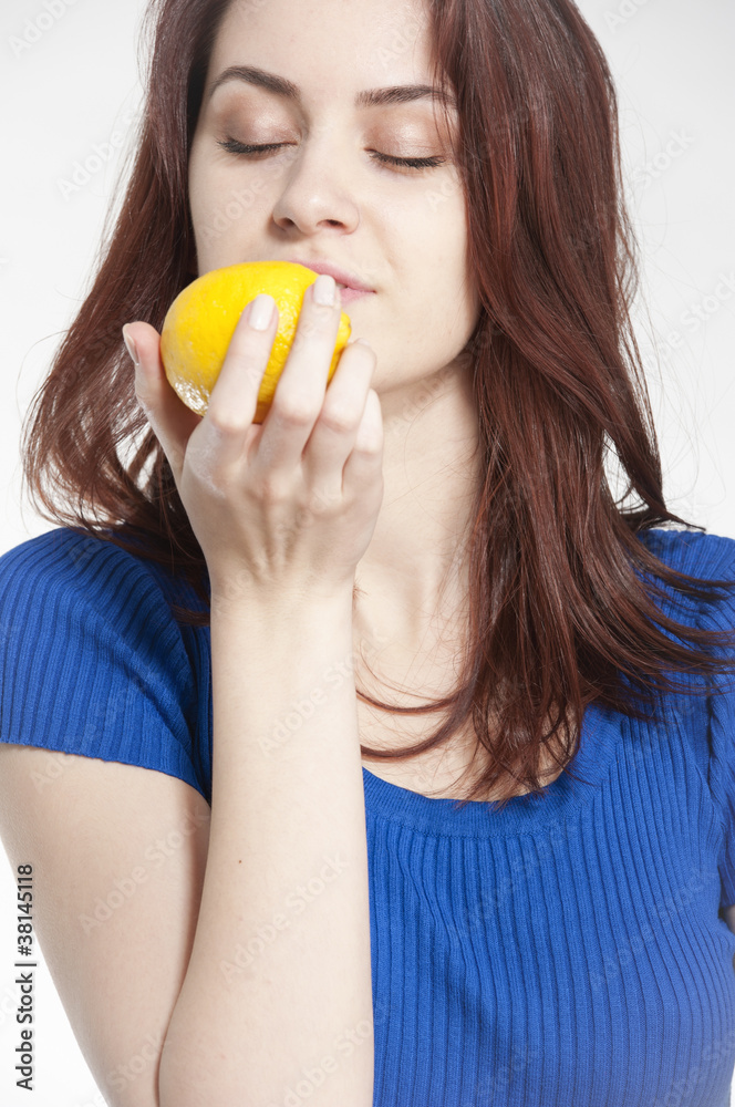 Young woman holding a lemon Young woman holding a lemon