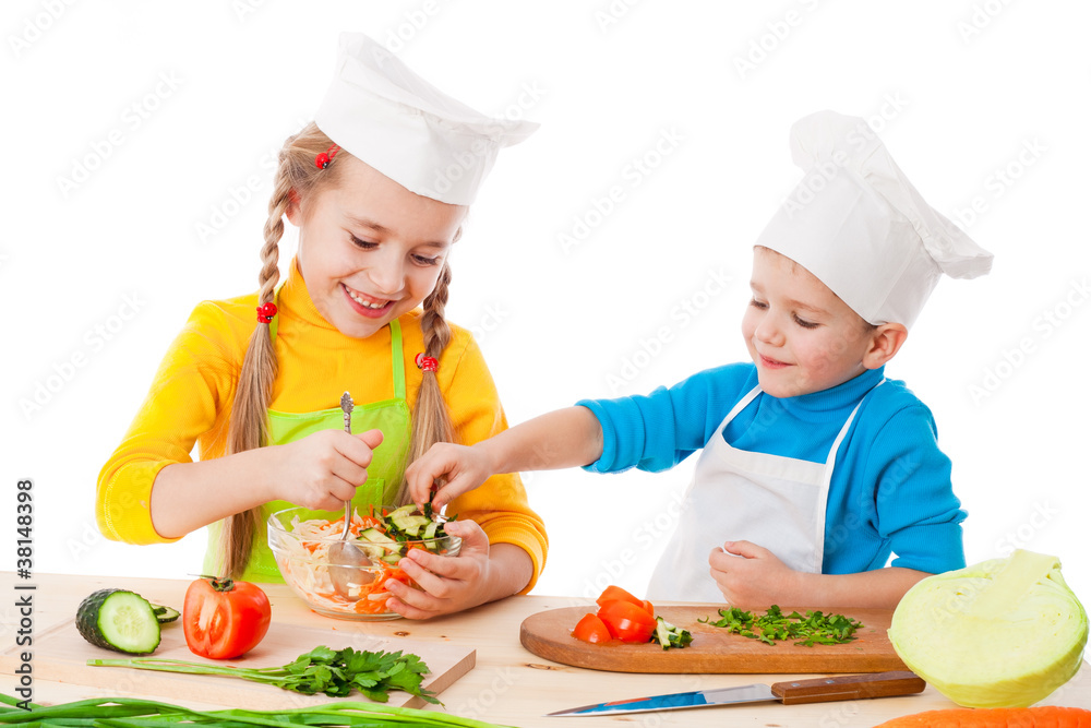 Two smiling kids mixing salad Two smiling kids mixing salad