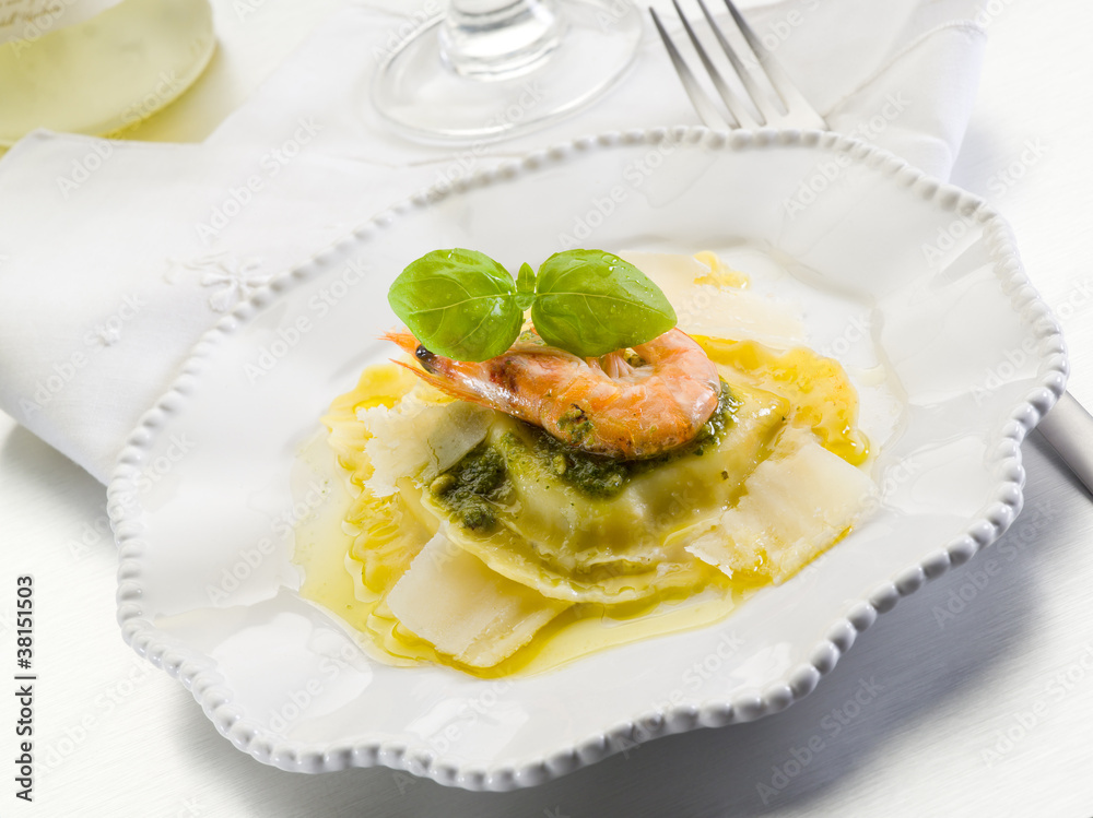 pesto ravioli with shrimp and parmesan flakes pesto ravioli with shrimp and parmesan flakes