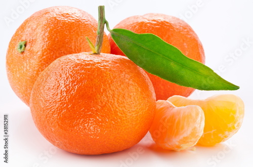 Tangerines with leaves on white background.