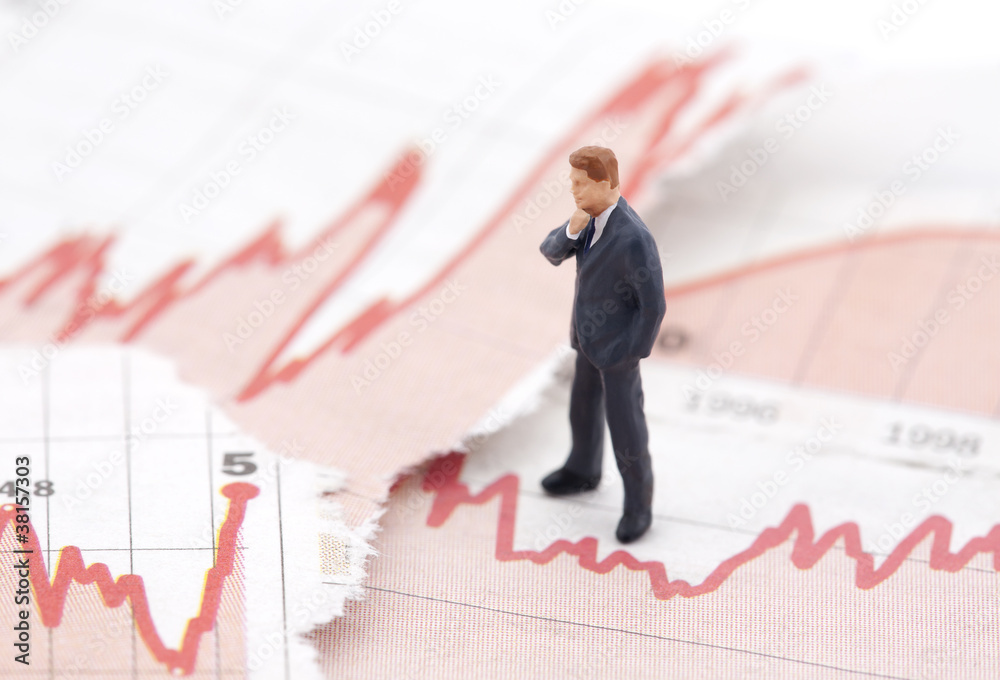 Financial crisis. Figure of businessman on financial charts
