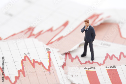 Financial crisis. Figure of businessman on financial charts