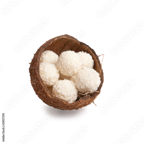 white chocolate truffles in a box of coconut halves isolated on