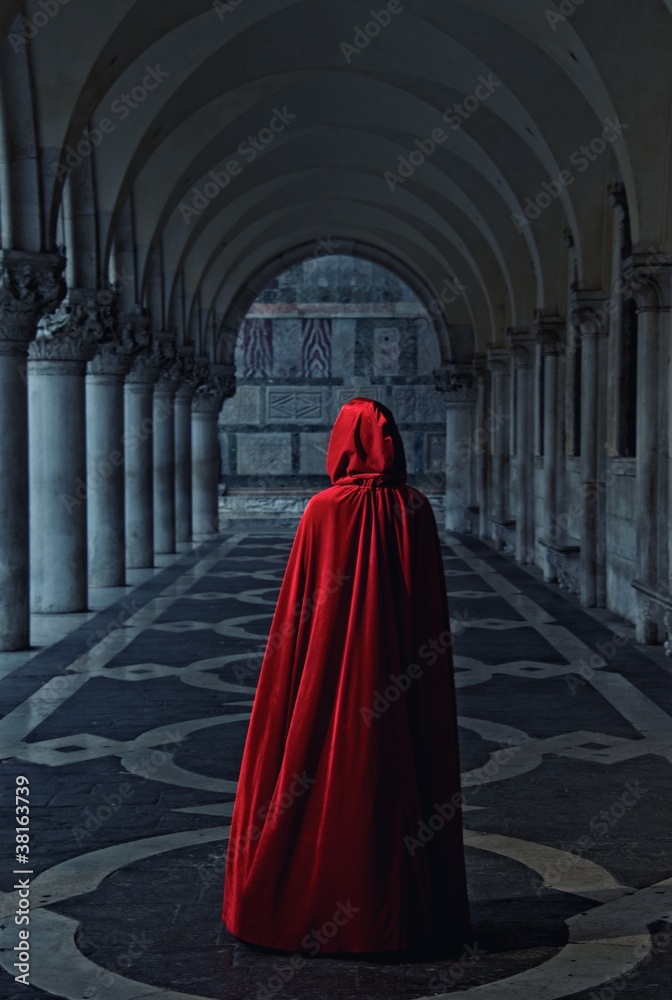 Woman in red cloak walking away