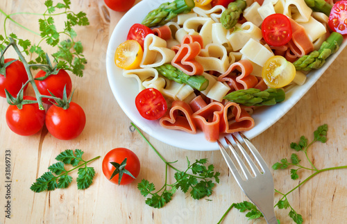 Delicious heart-shaped pasta with tomatoes and asparagus