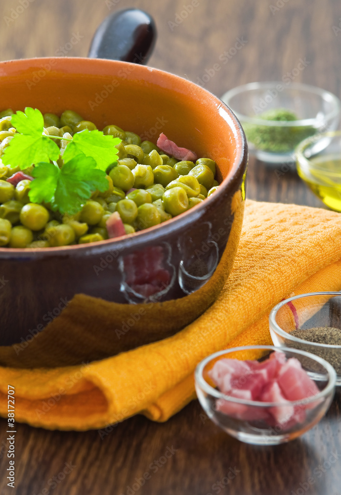 Peas with bacon in terracotta bowl. Peas with bacon in terracotta bowl.