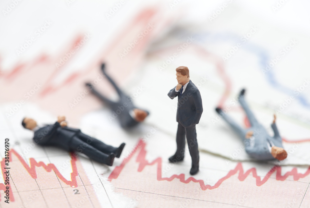 Financial crisis. Figures of businessman on financial charts Financial crisis. Figures of businessman on financial charts