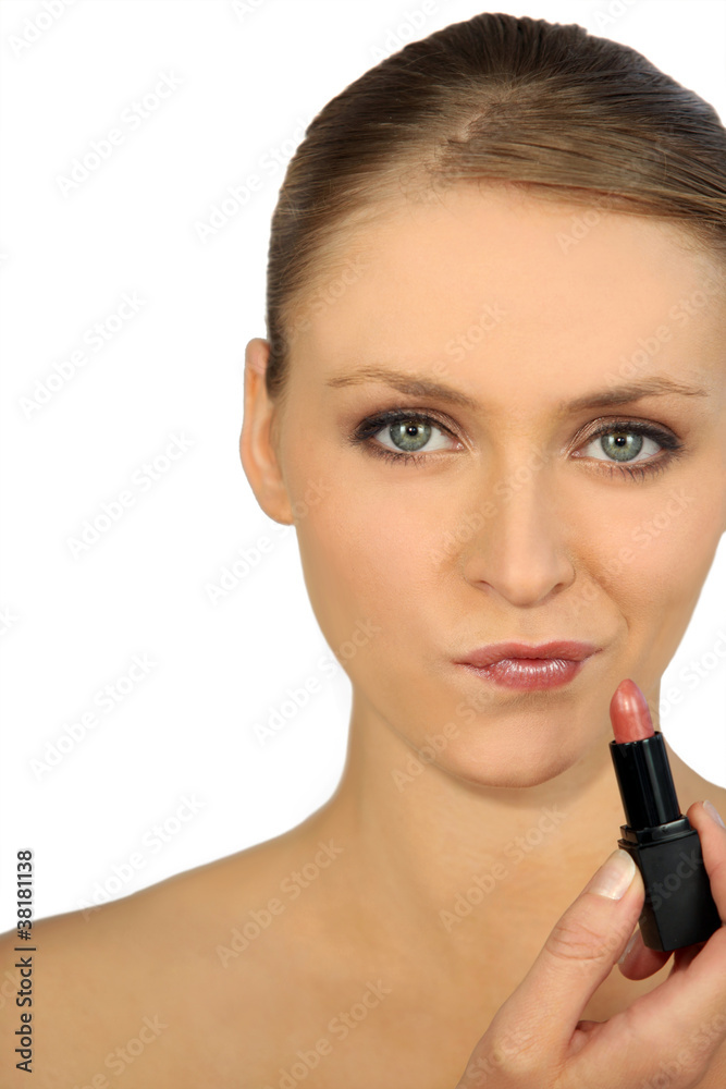 head and shoulders shot of graceful blonde putting on lipstick head and shoulders shot of graceful blonde putting on lipstick