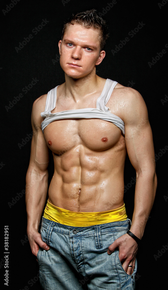 Muscular young wet sexy man in the white t-shirt Stock Photo | Adobe Stock